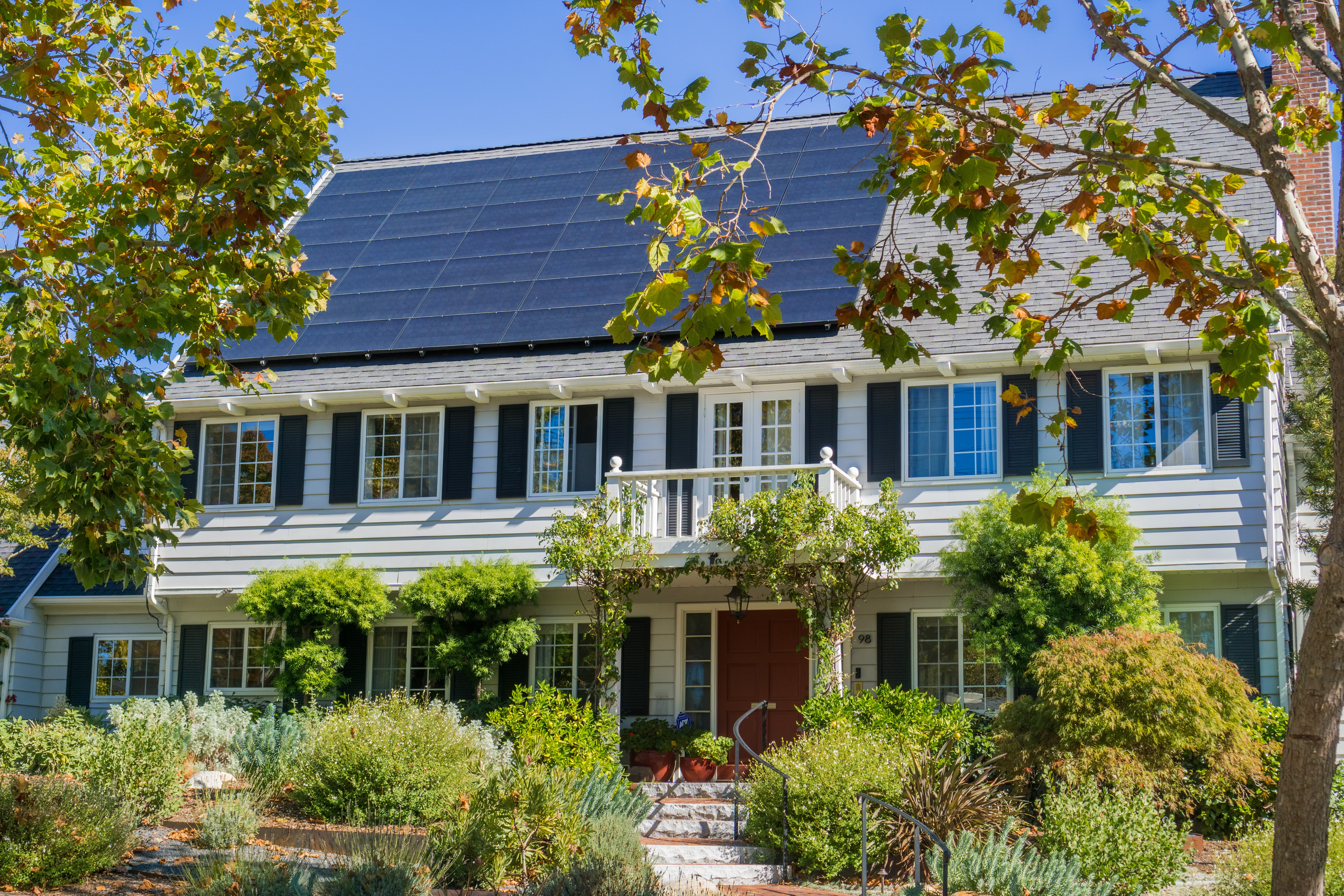 House with solar panels on the roof in a residential neighborhoo